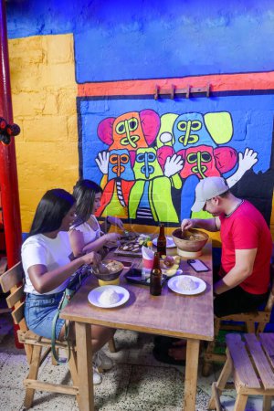 Photo for Group of friends eating typical Colombian food. Photo taken in Barranquilla - Royalty Free Image