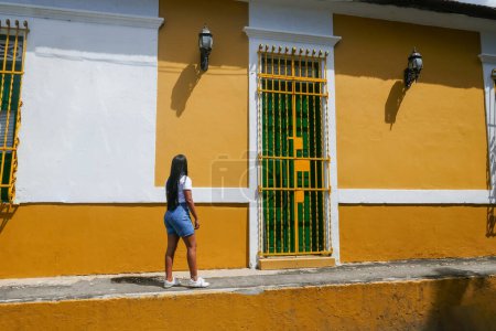 Photo for Woman walking through the streets of Barranquilla, Colombia - Royalty Free Image
