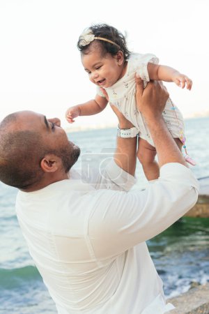Photo for African Father who lifts his baby in the air - Royalty Free Image