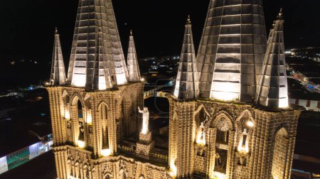 Illuminated Church Towers at Night with Jesus Christ Statue