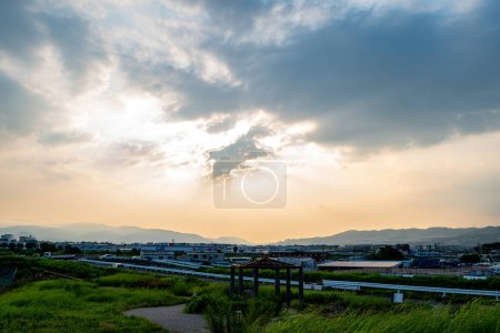 Photo for View of a town surrounded by mountains view in a cloudy day during afternoon (Ikeda, Osaka, Japan) - Royalty Free Image