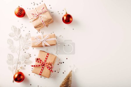 Photo for Christmas composition. Gifts, spruce branches, red decorations on a white background. Christmas, winter, new year concepts. Flat deck chair, top view, copy space. - Royalty Free Image