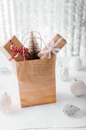 Photo for Shopping bag with gift boxes Christmas and New Year sale - Royalty Free Image