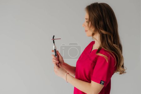 Ultraviolet curing light with UV light blocking glass in hands