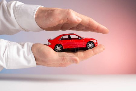 concept : car insurance red car accident in hand.