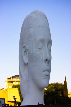 Photo for Madrid, Spain. May 9 2022. A work by Catalan sculptor Jaume Plensa called Julia at Plaza de Colon. A white sculpture in a form of a female head against a blue sky with white clouds. Spanish square. - Royalty Free Image