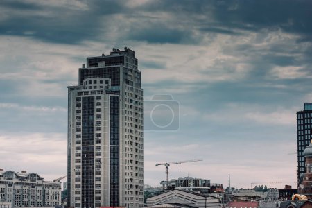 Photo for Kyiv, Ukraine. 1 July 2021 Modern high-rise building glass facade against an overcast blue sky. Business center development, metropolitan big city urban architecture. Cityscape panorama, bird's view. - Royalty Free Image