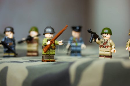 Photo for Kyiv, Ukraine. March 9, 2022. LEGO soldiers from Second World War. Toy soldiers in camouflage uniform with machine gun, weapon. Troops, regiment. War in Ukraine. Formations of armed forces, military. - Royalty Free Image