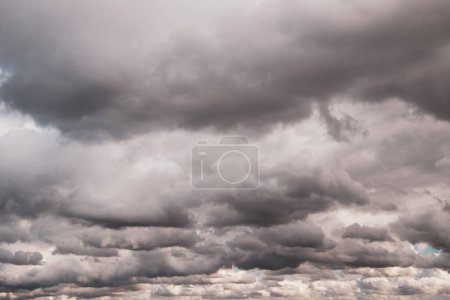 Photo for Low gray rain clouds thicken in the sky. The sky before the rain. Fall bad weather, hurricane, dangerous weather conditions, rainy season in October. Abstract natural skyline background. Fresh air. - Royalty Free Image