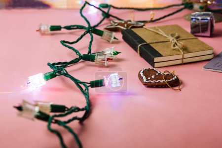 Old retro vintage green LED garland lights for Christmas tree. New year decor details. Festive decoration isolated on pink background. Holiday party fiesta. Merry Christmas. Presents, gift for a woman