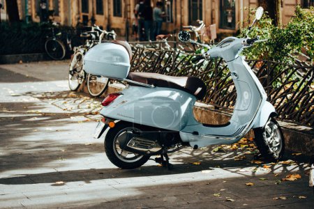 Photo for France, Paris. October 8, 2023. Blue scooter parked on a city street. A small motorized vehicle. Old style Vespa scooters on cozy little town street. - Royalty Free Image