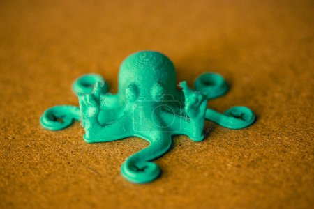 Toy green octopus with tentacles created from recycled plastic. DIY toy character of an underwater world inhabitant. Sea, ocean animal creature. 