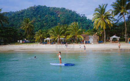 Photo for Thai women paddling at a sup board in Koh Chang Thailand. stand-up paddleboard - Royalty Free Image