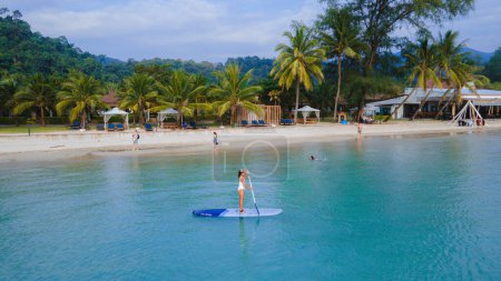 Photo for Women paddling at a sup board in Koh Chang Thailand. stand-up paddleboard - Royalty Free Image