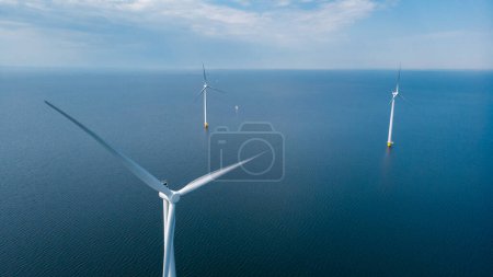 Photo for Windmill turbines at sea with a blue sky, Wind mill Turbine in ocean in the Netherlands - Royalty Free Image