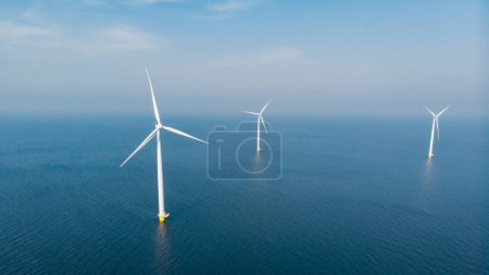 Photo for Windmill turbines at sea view from a drone aerial view from above at a huge windmill park - Royalty Free Image
