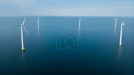 Photo for Drone view at Windmill turbines at sea , view from above at a huge windmill park in the Netherlands. - Royalty Free Image