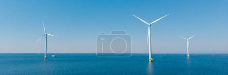 Photo for Drone view at Windmill turbines at sea , view from above at a huge windmill park in the Netherlands. - Royalty Free Image