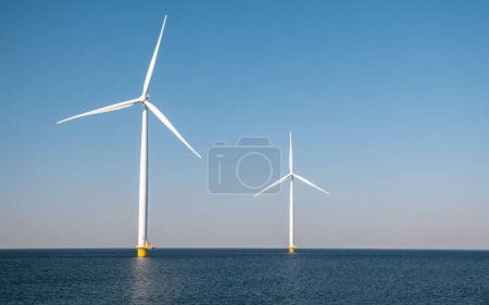 Photo for Windmill turbines in the Netherlands at sea with a blue sky - Royalty Free Image