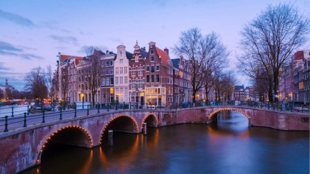 Photo for Amsterdam Netherlands canals with Christmas lights during December evening in the winter, canal historical center of Amsterdam at night. - Royalty Free Image