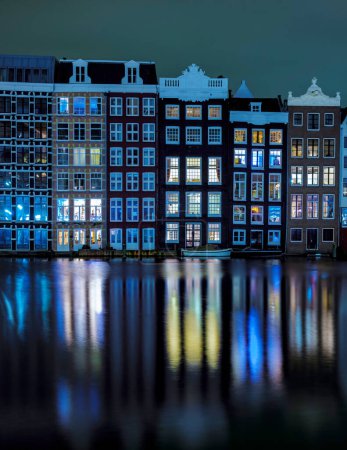 Photo for Amsterdam Netherlands canals with lights during the evening in December during wintertime in the Netherlands Amsterdam city. Europe. - Royalty Free Image