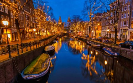 Foto de Navidad en los canales de Amsterdam con luces de Navidad durante diciembre, Noche de invierno en el centro histórico del canal de Amsterdam por la noche. - Imagen libre de derechos