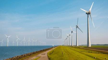 Photo for Wind mill park with Windmill turbines generating electric with a blue sky green energy concept - Royalty Free Image