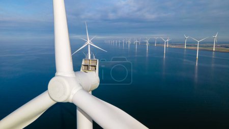 Photo for Drone view at Windmill park with wind mill turbines generating electricity with a blue sky green energy concept - Royalty Free Image