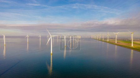 Photo for Windmill turbines at sea seen from a drone aerial view from above at a huge windmill park in the Netherlands - Royalty Free Image