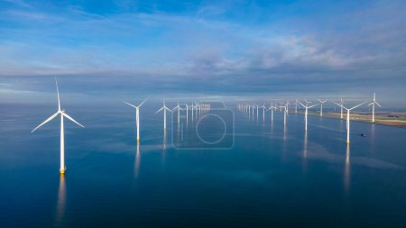 Photo for Windmill turbines at sea seen from a drone aerial view from above at a huge windmill park in the Netherlands - Royalty Free Image