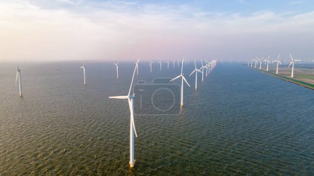Photo for Drone view at windmill turbines generating electricity - Royalty Free Image