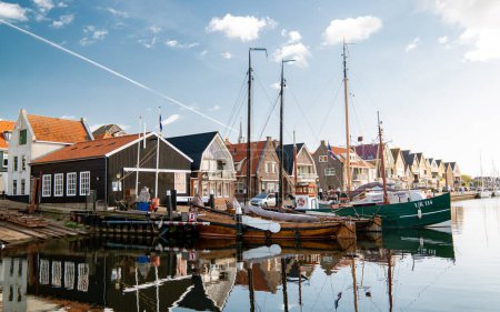 Photo for Urk Netherlands September 2020, old harbor of Urk with fishing boats and reflection in the water. - Royalty Free Image