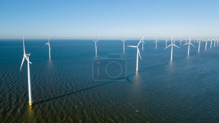 Photo for Aerial view at Windmill park with wind mill turbines generating electricity with a blue sky green energy concept - Royalty Free Image