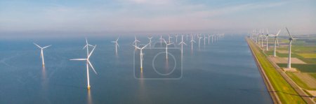 Foto de Turbinas de molinos de viento que generan electricidad con un concepto de energía verde del cielo azul en los Países Bajos - Imagen libre de derechos