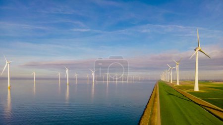 Photo for Aerial view at Windmill park with wind mill turbines generating electricity with a blue sky green energy concept - Royalty Free Image