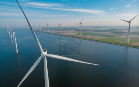 Photo for Windmill turbines at sea with a blue sky green energy concept - Royalty Free Image