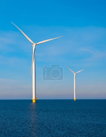 Photo for Aerial view at Windmill park with windmills turbines during winter generating electricity with a blue sky green energy concept - Royalty Free Image