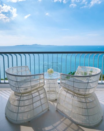 Téléchargez les photos : Chaises sur le balcon avec vue sur l'océan bleu sur le balcon d'un hôtel - en image libre de droit