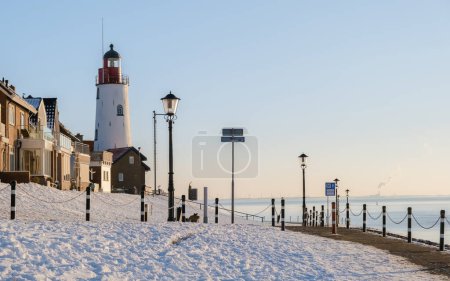 Téléchargez les photos : Phare d'Urk en hiver avec neige aux Pays-Bas par une journée froide en hiver. - en image libre de droit