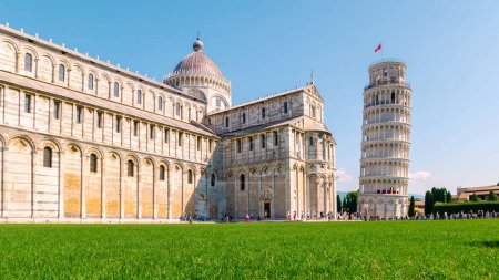 Photo for Leaning tower of Pisa, Italy with Basilica and Cathedral on a bright summer day with green grass low angle. - Royalty Free Image