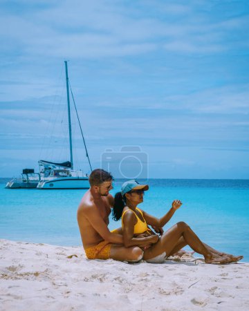 Photo for Small Curacao Island famous for day trips , a couple on the beach of Klein Curacao Island men and woman on the beach during a vacation holiday - Royalty Free Image