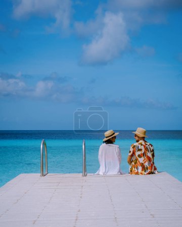 Photo for A couple visit Playa Porto Marie beach Curacao, white tropical beach with turqouse water ocean, couple men and women on vacation in Curacao - Royalty Free Image