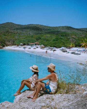 Photo for Couple visit Grote Knip beach, Curacao, Netherlands with a blue ocean Curacao Caribbean Island, couple men and woman visiting Curacao on vacation at the beach - Royalty Free Image