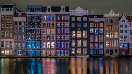 Photo for Colorful street with houses at the Damrak in Amsterdam, they call it the dancing house of Amsterdam - Royalty Free Image