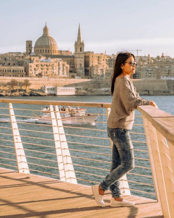 Photo for Valletta Malta city Skyline, colorful house balcony Malta Valletta city, young Asian woman visit Malta during a vacation - Royalty Free Image