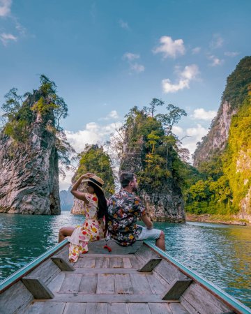 Photo for Couple in front of a Longtail boat during a trip in Thailand. men and women in front of Longtail Boat at Khao Sok - Royalty Free Image