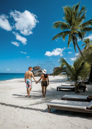 Photo for Saint Lucia Caribbean Island, couple of men, and woman on vacation at the tropical Island of St Lucia beach, Anse Chastanet beach during summer - Royalty Free Image