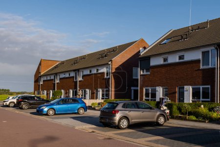 Photo for Dutch Suburban area with modern family houses, newly build modern family homes in the Netherlands, dutch family house on a sunny day - Royalty Free Image