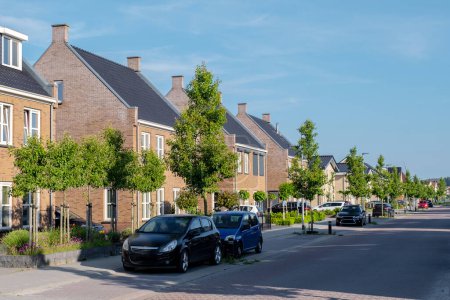 Photo for Dutch Suburban area with modern family houses, newly build modern family homes in the Netherlands, dutch family house neigborhood - Royalty Free Image