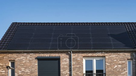 Photo for Newly build houses with solar panels attached on the roof against a sunny sky, renewable energy green energy - Royalty Free Image